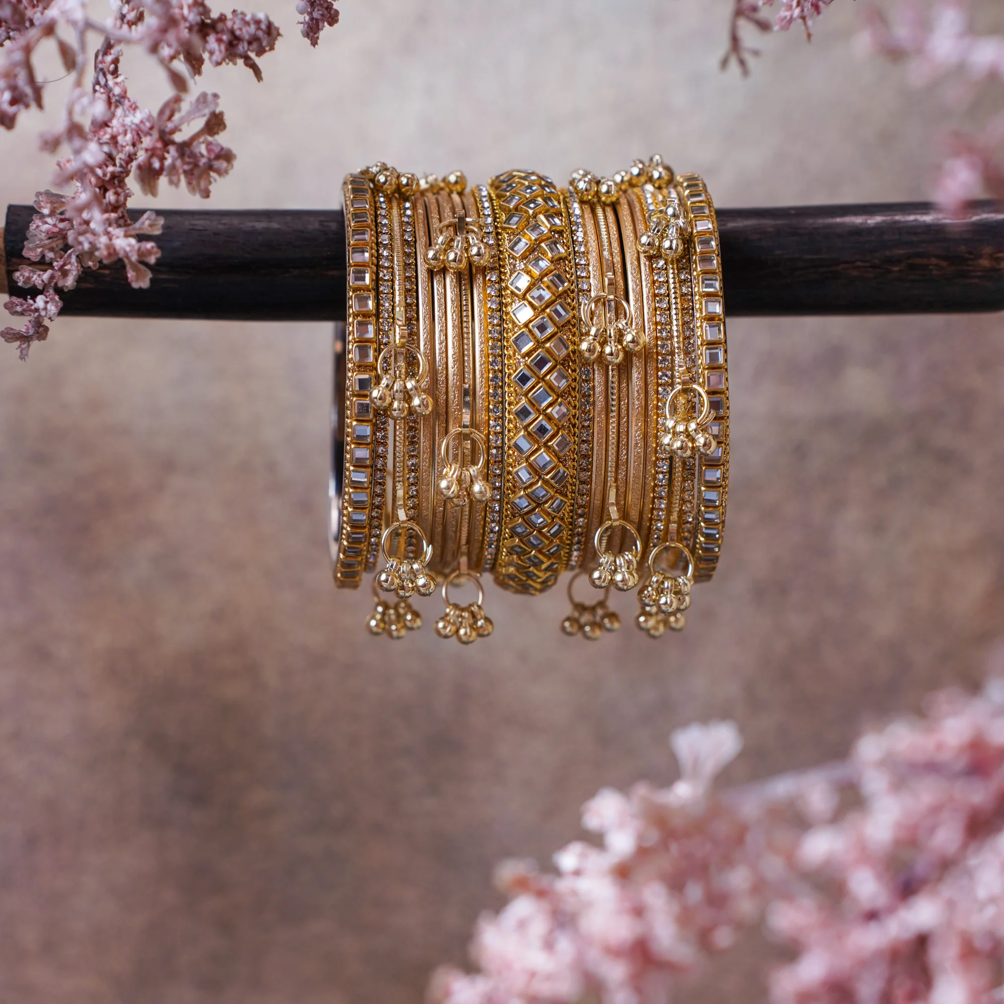 A stunning full gold stack featuring a blend of beautifully textured bangles with delicate ghungroo accents. Rich, radiant, and festive, this is designed to stand out.